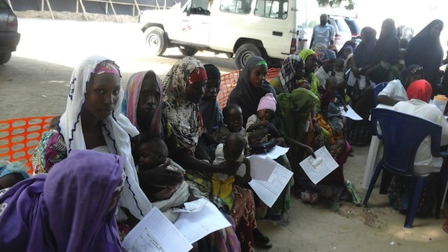 Displaced women queue for food at an MSF facility