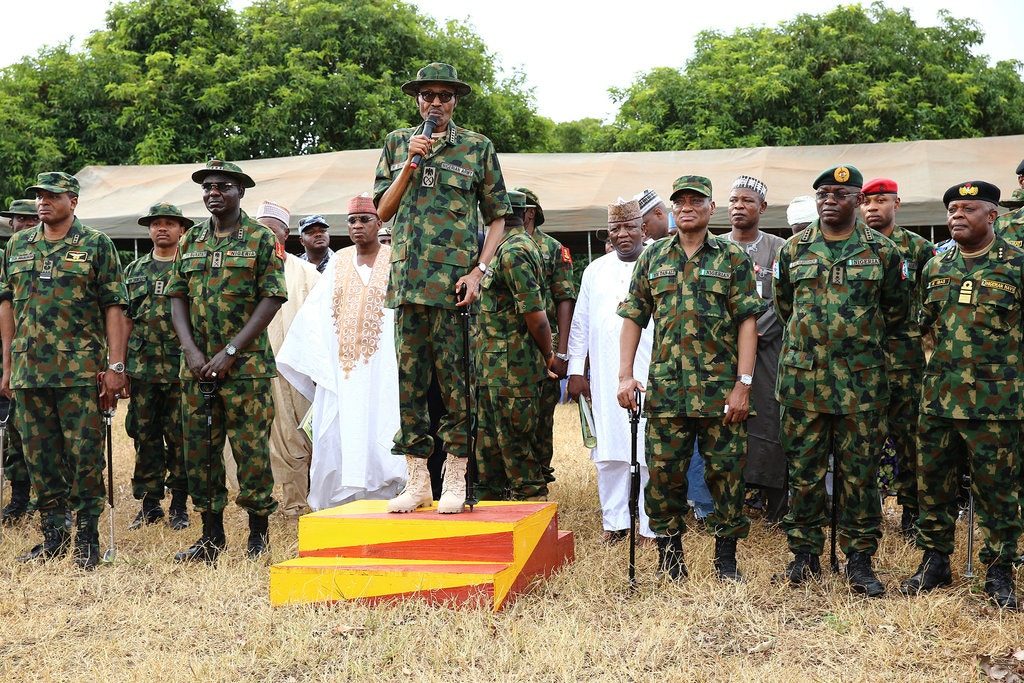 President Muhammadu Buhari of Nigeria, center, flanked by former service chiefs and other senior military officers, spoke during the Army Day celebration in Dansadau, in Zamfara, in 2016. 