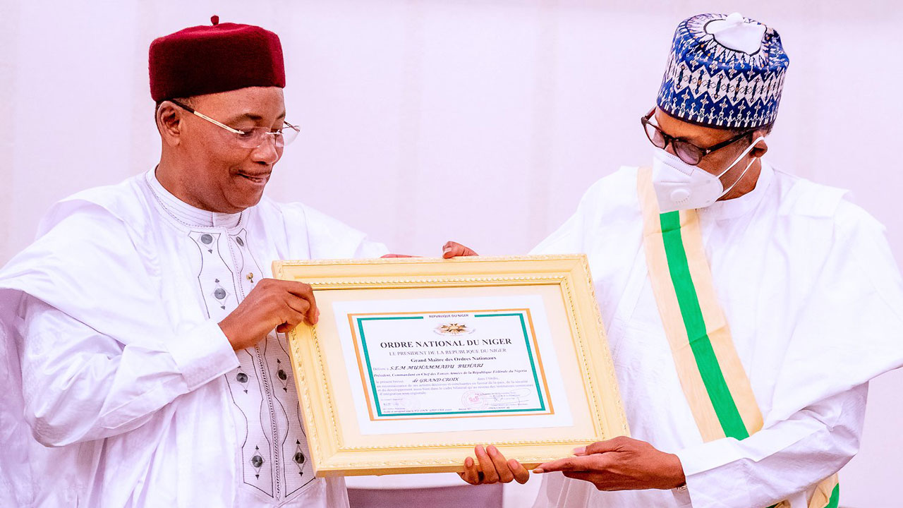 Buhari receives Niger Republic's highest national honour from then President Mahamadou Issoufou at the Presidential Villa in Abuja