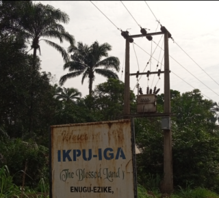 Sign post at the entrance of Ikpu-Iga with an abandoned world bank electrification project. Photo by Sodiq Ojuroungbe