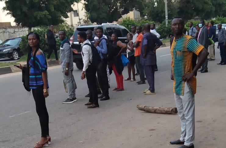 Abuja residents waiting for transport to their homes in satellite towns after work