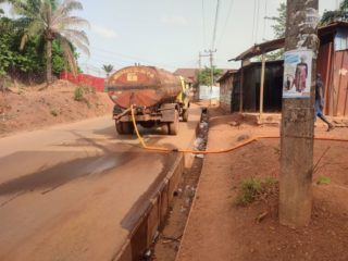 A tanker driver delivers water for use