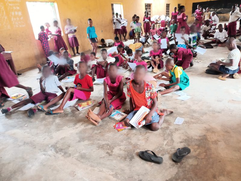 Pupils of St Paul African Church School, Ibaka, Mbo LGA writing examination on nude floor. Credit: Ekemini Simon.