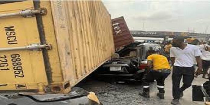 A truck laden with two 20-feet containers that fell on three vehicles at Cele bus-stop end of Oshodi/Apapa expressway, Lagos in 2022