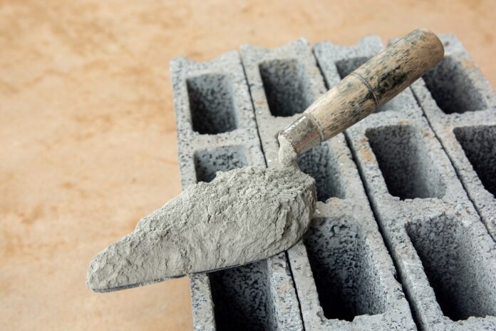Cement powder or mortar with trowel put on the Concrete brick for construction work. by NaMaKuKi via Free Stock photos by Vecteezy 