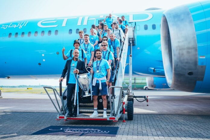 Manchester City display their trophy. Photo via @Mancity on Twitter