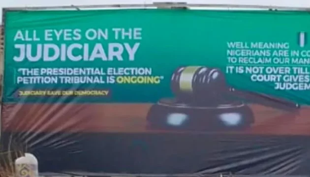 A variation of the All eyes on the judiciary billboard.