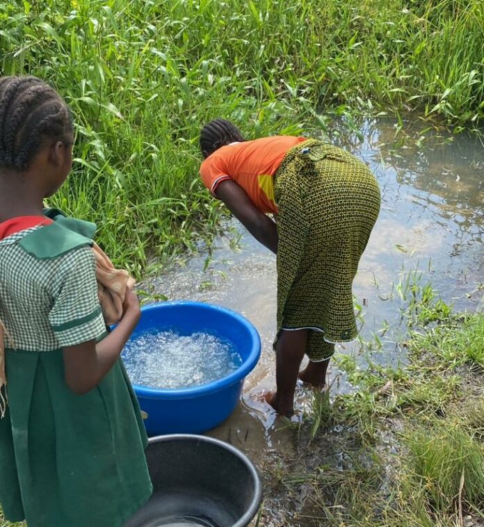 Issa Rose, a twenty-six-year-old resident of Bassa, along side her younger sister, fetching water from their only water source. Pc: TheICIR/2023