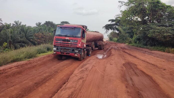 Truck carrying product gets stuck trying to navigate the 9th Mile-Orokam road.