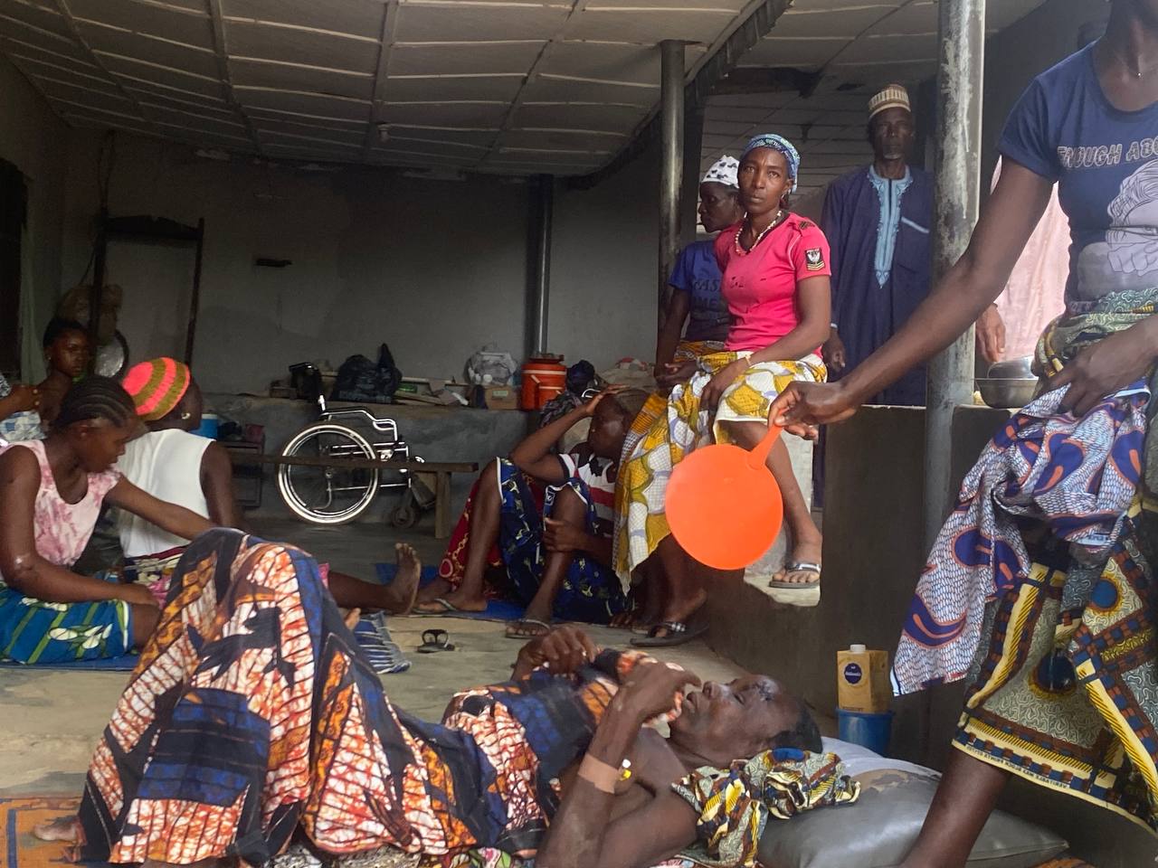 Survivors and relatives attend to injured persons receiving treatment at Shalom Nursing Home.