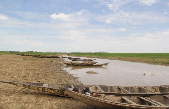 Wooden canoes line the shore of the River Niger in Yauri, Kebbi State, after fishermen returned from a day of poor catches, which they attribute to declining water levels.