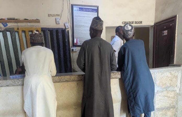 Police officer attending to citizens at the Farm Centre Police Station
